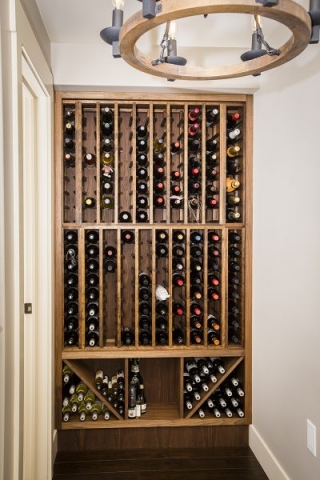 The wine rack was a great use of an odd space at the end of a small hallway. It was the client’s idea to transform the space into wine storage where they could sort both bottles by the case, one-off bottles, and different size bottles such as ice wine and magnums. Photo: Bruce Murray, VisionFire Studios
