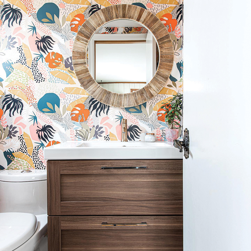 The warm wood tones of the cabinet, mirror and botanical print wallpaper give dimension and depth to a bathroom remodel. Photo: Matthew McMullen / Virginia Ann Interiors