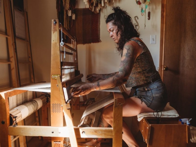 Megan works in natural fabrics and natural light. Her loom becomes a part of the journey, creating textiles to be used for generations. Photo: Kirsten Pope