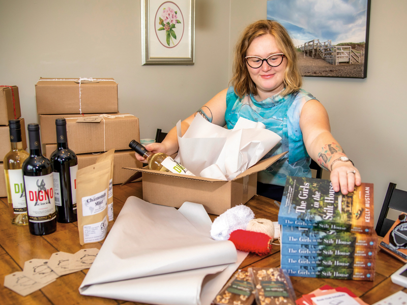 Read between the Vines founder Emma Bent packs up the books and pairings for December members.  Photo: Bruce Murray, Visionfire Studios