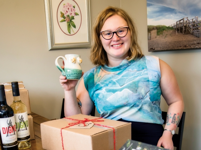 Emma Bent enjoys a cup of coffee in her favourite mug while she packs subscription boxes for local delivery.  Photo: Bruce Murray, Visionfire Studios